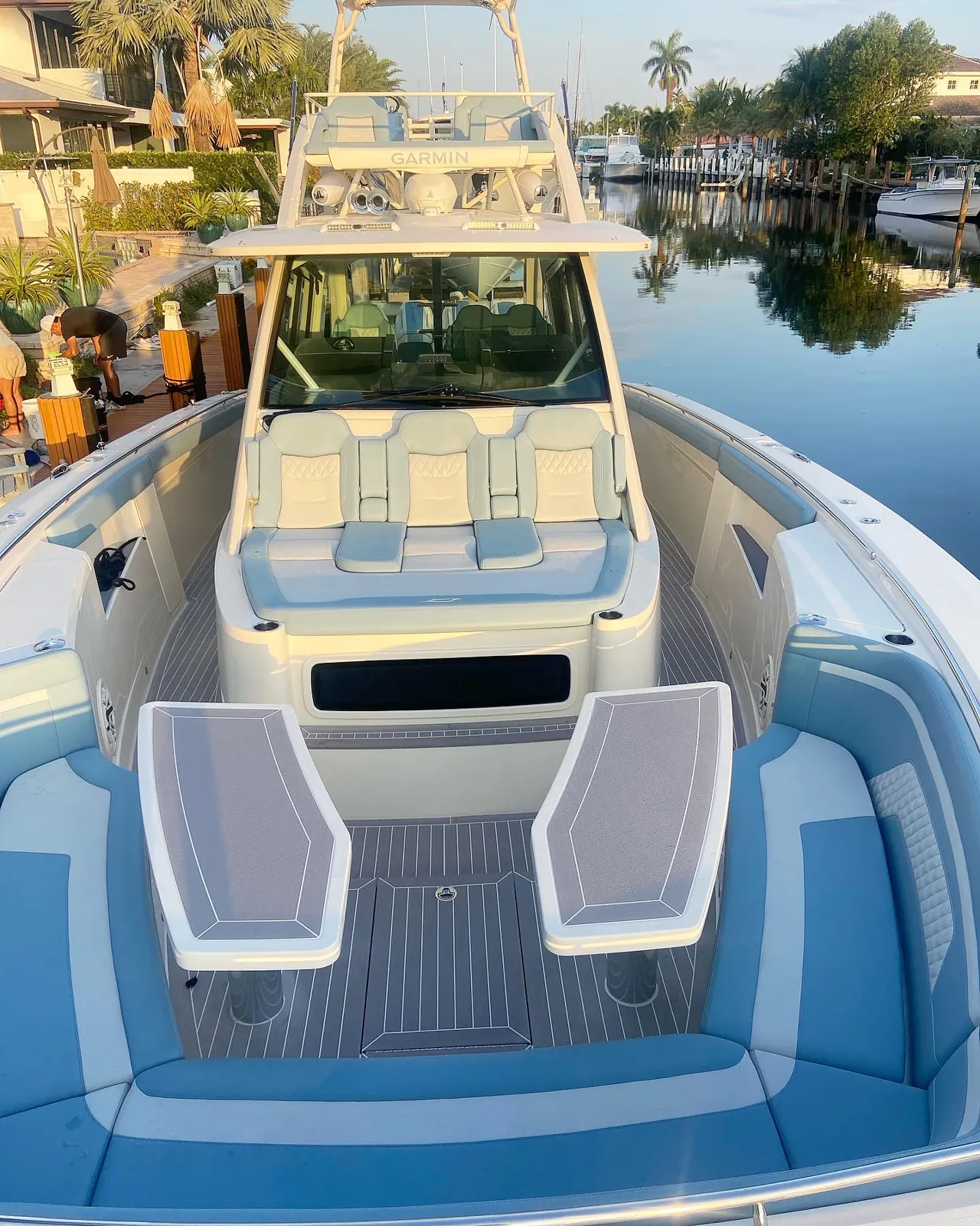 Spotless Scout center console with blue and white seating at a canal dock in Lighthouse Point, Florida